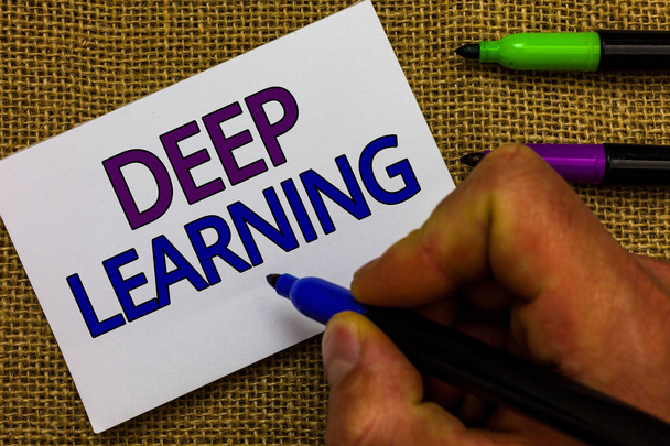 Text sign showing Deep Learning. Conceptual photo Hierarchical Abstractions Artificial Intelligence Algorithm Man hand holding marker white paper communicating ideas Jute background. - Photo, Image