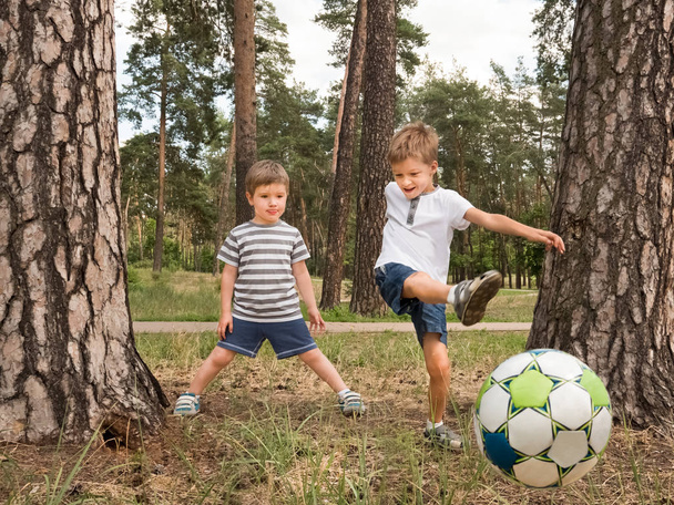 Children playing soccer outdoor. Leisure activities for children - Photo, Image