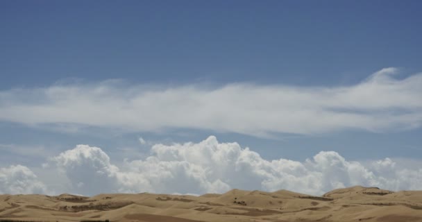 4k timelapse большие белые пухлые облака массы прокатки над песчаными дюнами пустыни
. - Кадры, видео