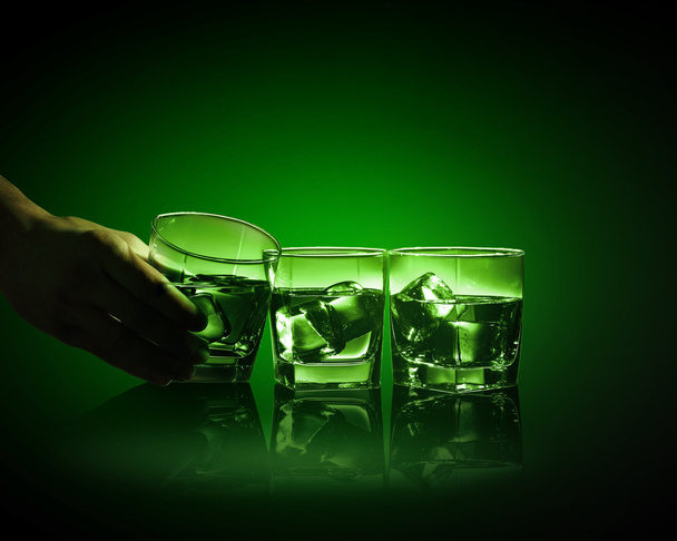 Three glasses of green absinth with ice cubes - Photo, image