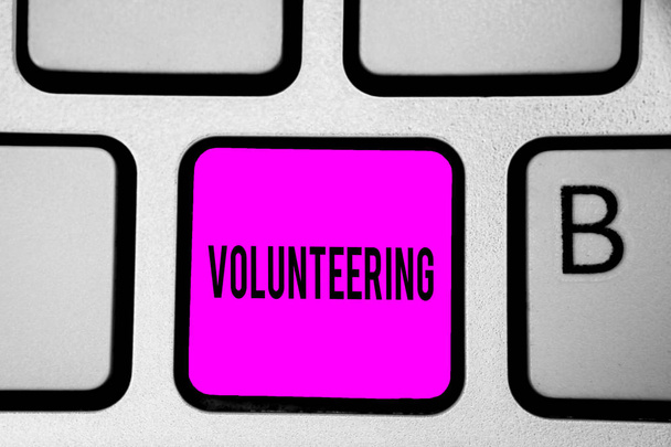 Conceptual hand writing showing Volunteering. Business photo text Provide services for no financial gain Willingly Oblige Keyboard purple key Intention create computer reflection document. - Photo, Image