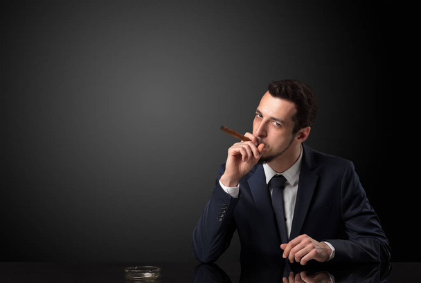 Businessman holding cigarette. - Photo, image