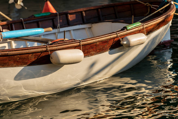 One wooden rowing boat moored in a port of Liguria, Italy, Europe - Photo, Image
