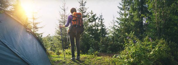 tourist girl stands near the tent in the  mountain. Carpathians,  Ukraine - 写真・画像