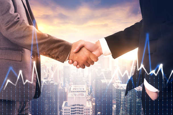 Two unrecognizable businessmen shaking hands. Evening city view background. Forex diagram foreground. Toned image double exposure mock up - Photo, Image