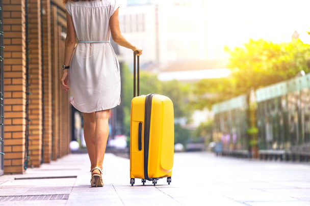 girl traveler and her yellow  luggage. wonderful trave - Photo, image