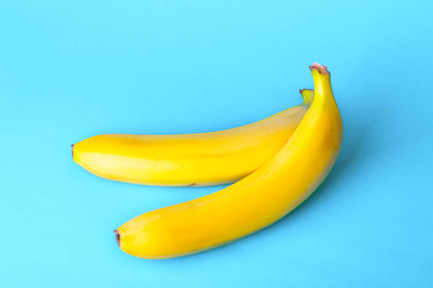 delicious ripe bananas on a blue backgroun - Foto, Imagen