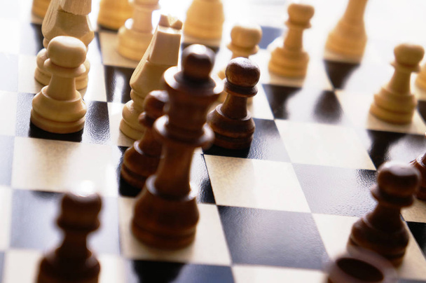 Chess figures on a wooden chess board - 写真・画像