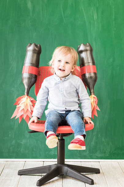 Happy child in class. Funny kid against chalkboard. Back to school. Education concept - Foto, imagen