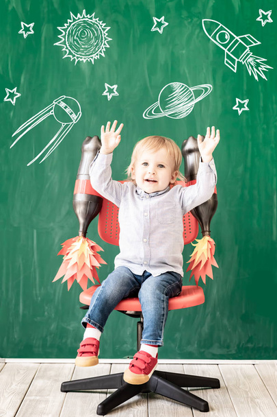 Happy child in class. Funny kid against chalkboard. Back to school. Education concept - 写真・画像