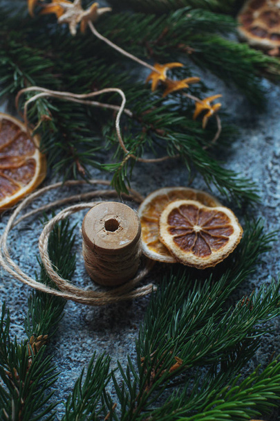 Christmas still life with dry oranges, cinnamon, fir branches and glove - Valokuva, kuva