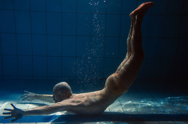 athletic sport man underwater in the swimming pool - Photo, Image