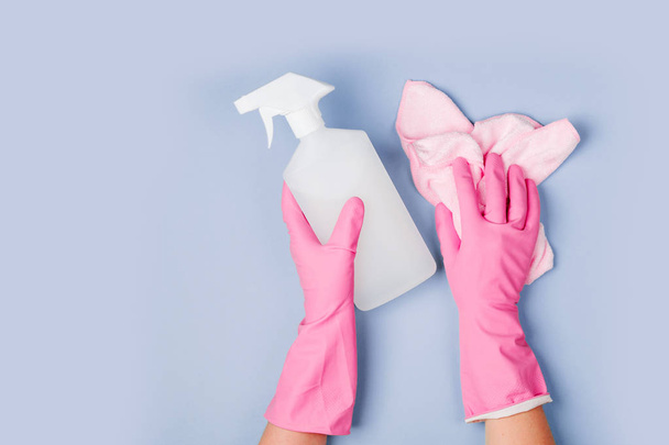 hands in rubber gloves holding cleanser spray and microfiber cloth - Valokuva, kuva