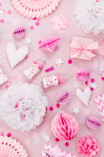 top view of pink and white decorations for Baby party on pink background - Foto, afbeelding