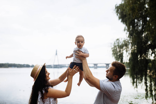 Happy young family with small son in the park - Valokuva, kuva