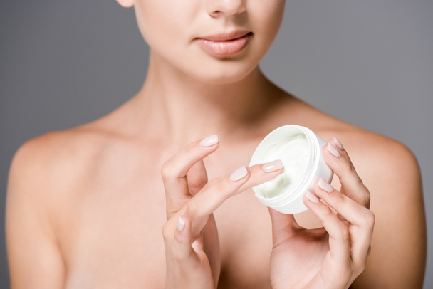 partial view of woman with face cream isolated on grey - Photo, Image