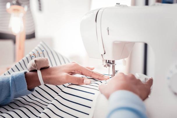 Close up of sewing process in well equipped showroom - Foto, Imagem