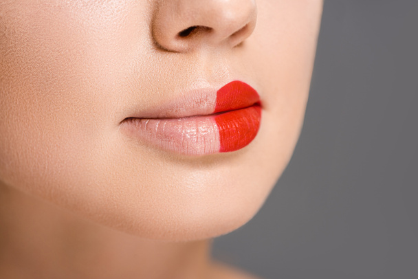cropped shot of woman with red lipstick on half of mouth isolated on grey - Φωτογραφία, εικόνα