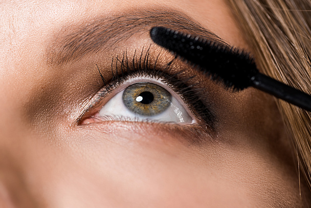 partial view of attractive woman and mascara brush - Photo, Image