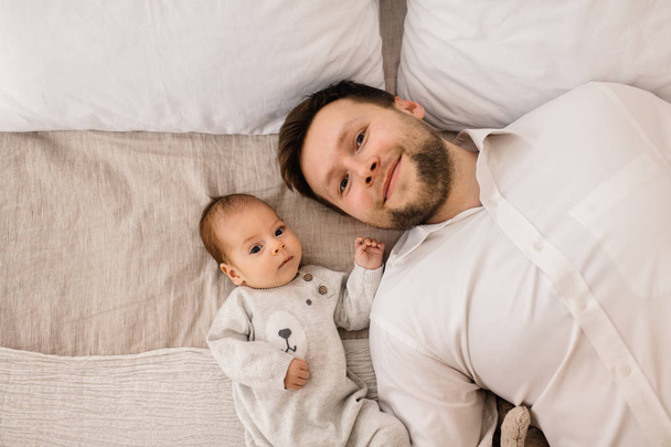 Happy young  father with little baby boy - 写真・画像