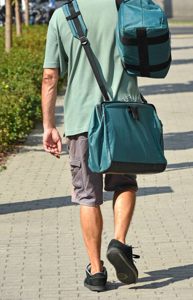 Postman on the street with bags - Foto, Imagen