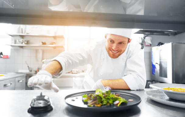 happy male chef cooking food at restaurant kitchen - Фото, зображення