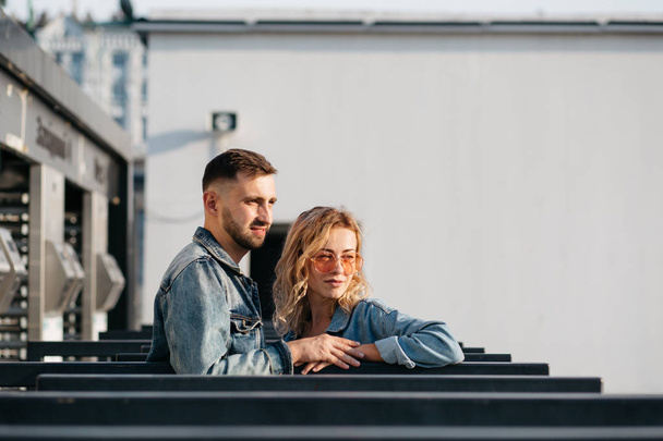 distant view of young adult couple looking away outdoors - Foto, imagen