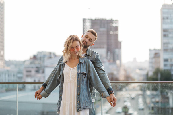 scenic view of young adult couple against modern cityscape  - Фото, зображення