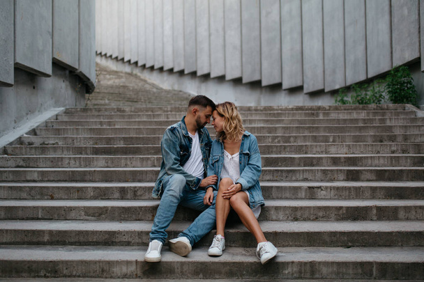 young adult couple in casual clothing on concrete steps - Foto, Imagem