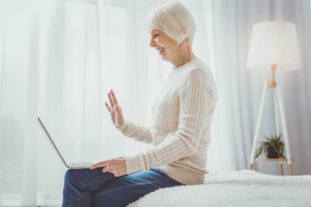 Happy senior woman communicating online - Foto, imagen