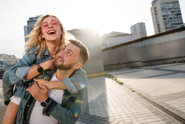 young adult couple fooling around on city street - Valokuva, kuva
