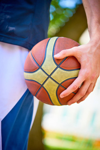 Close view of man holding basketball in hand - Foto, Imagem