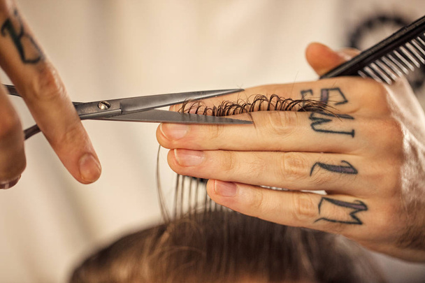 Haircut at barber shop with scissors close up - Фото, изображение