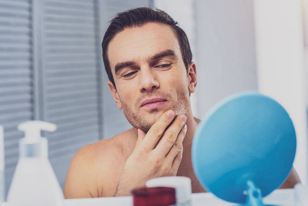 Male model taking care of his skin before photo session - Foto, afbeelding