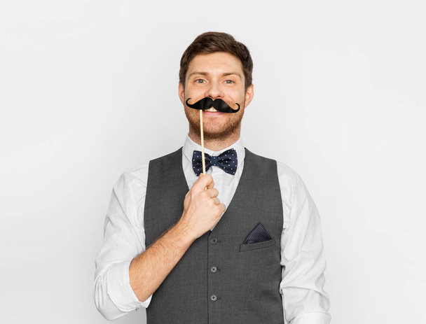 happy young man with fake moustache - Photo, image
