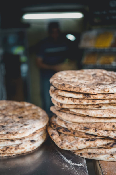 Pile of Traditional Israeli baked  flat bread on a market stall at Jerusalem Old City Market - Photo, image