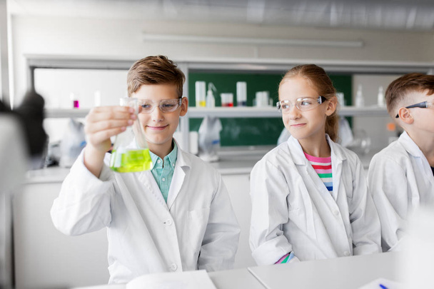 kids with test tubes studying chemistry at school - Fotó, kép