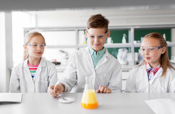 kids with test tube studying chemistry at school - Фото, изображение