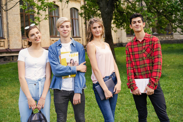 College students    with books at the school courtyard                                   - Zdjęcie, obraz