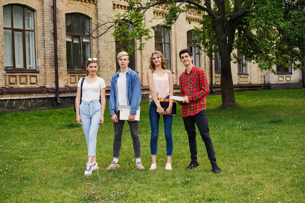 College students    with books at the school courtyard                                   - Фото, изображение
