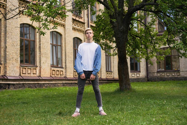  Portrait of handsome young university student   at the school courtyard        - Fotó, kép