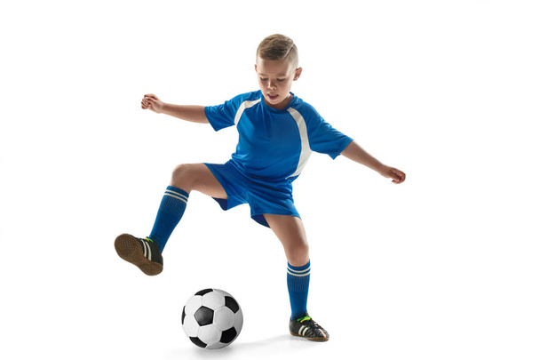 Young boy with soccer ball doing flying kick - Foto, afbeelding