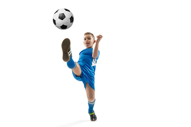 Young boy with soccer ball doing flying kick - Foto, Imagen
