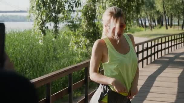 Beautiful young blonde posing outdoors - Filmati, video