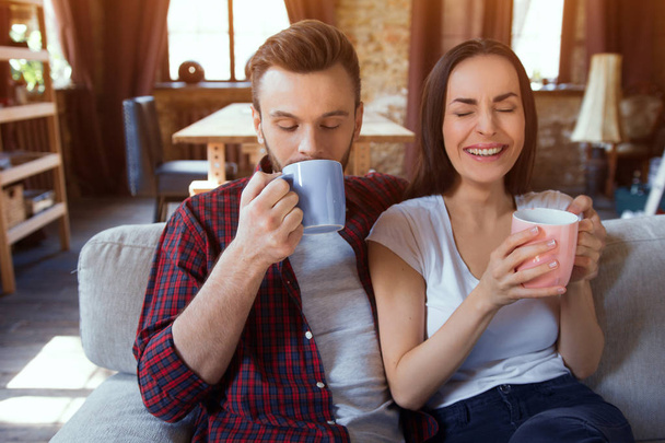 Lovely couple drinking coffee together. - Zdjęcie, obraz