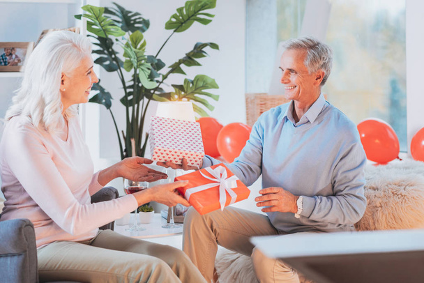Happy mature people exchanging with presents - 写真・画像