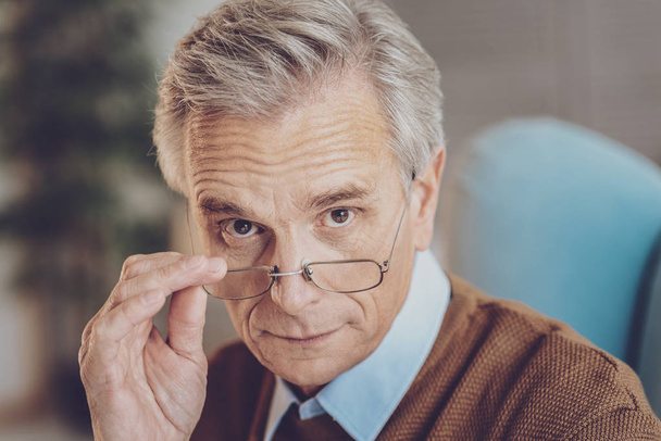 Portrait of mature man that touching glasses - Фото, изображение