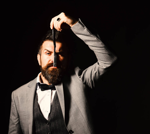 Macho in formal suit shaves beard. Man with long beard - Zdjęcie, obraz