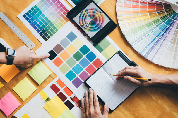 Young creative team having a meeting in creative office, Architectural drawing with work tools and accessories, Color swatch samples chart for selection coloring. - Φωτογραφία, εικόνα