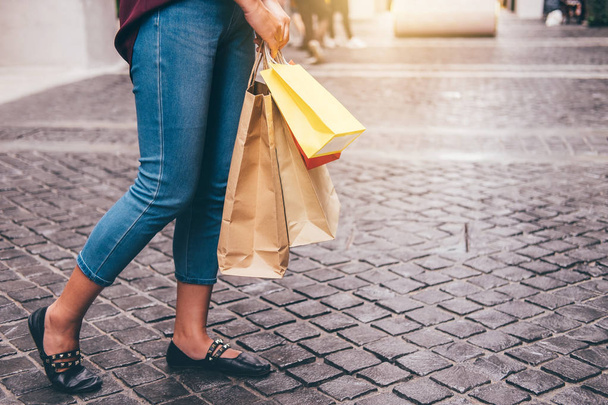 Consumerism, shopping lifestyle concept, Young woman standing and holding colorful shopping bags enjoying in shopping. - Photo, Image
